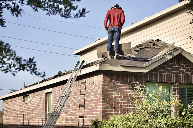 Professional roofer working on a residential roof in Sunset Whitney
